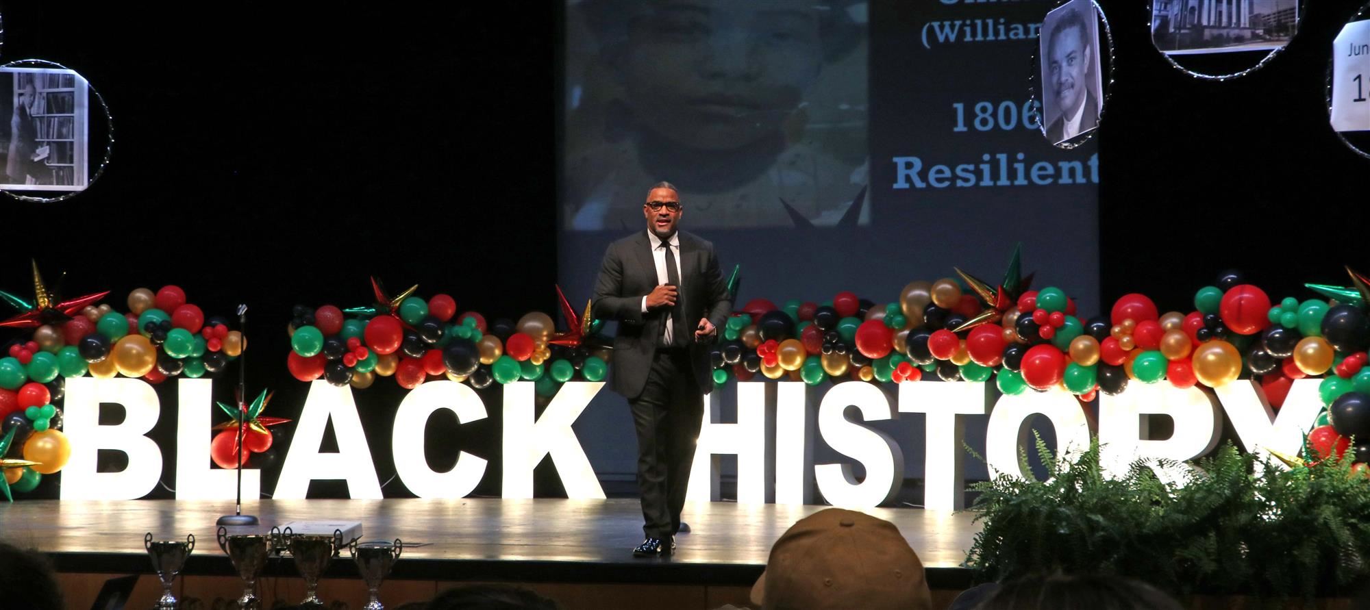 Dr. McFarland on stage of Black History Bowl